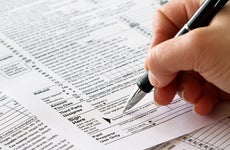 woman signing tax returns