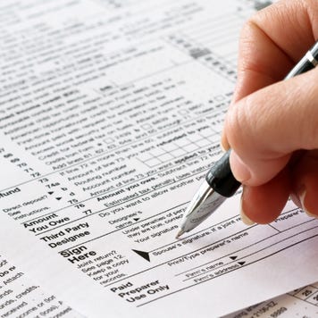 woman signing tax returns
