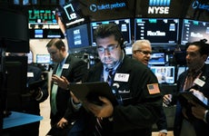 Traders work on the floor of the New York Stock Exchange.