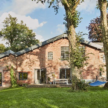 Residential house with hammock in garden.