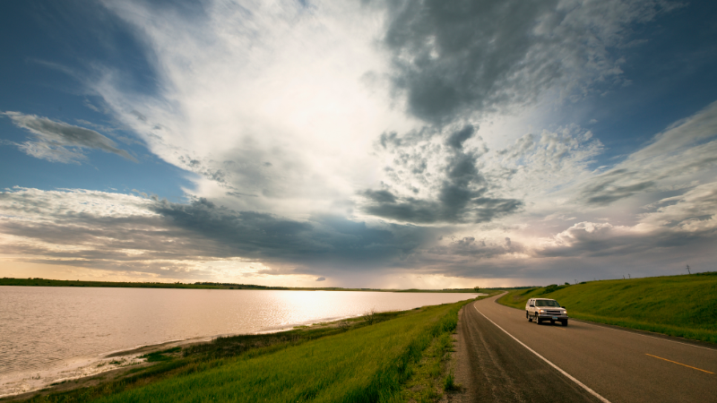 SUV driving along a lake in McHenry County, North Dakota