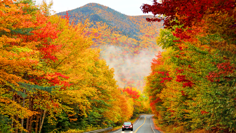 SUV driving down the Kancamagus Highway in Northern New Hampshire