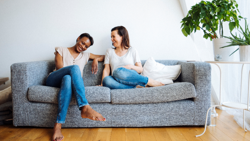 Friends laughing on the couch