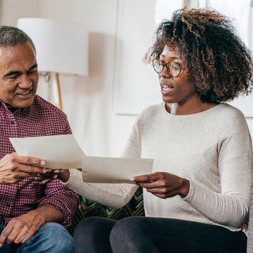 Senior African-American man receiving a home consultation from an African-American woman.