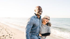 Senior couple walking on the beach