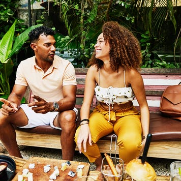 a couple sitting down and dining