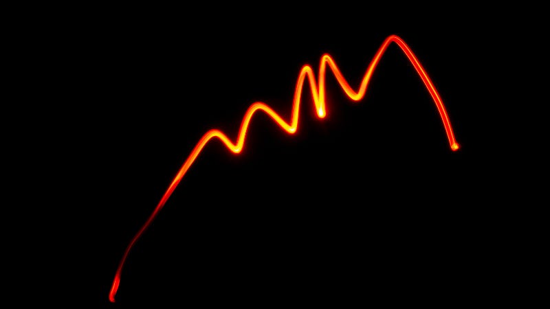 An image of an orange wavy line on a black background
