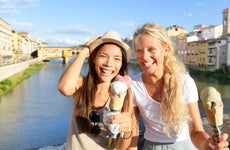 Young female friends enjoying ice cream in Florence, Italy