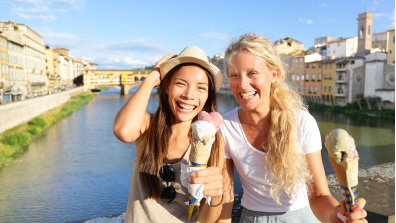 Young female friends enjoying ice cream in Florence, Italy