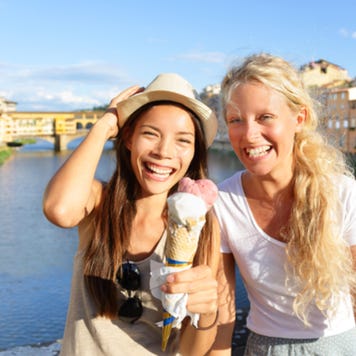 Young female friends enjoying ice cream in Florence, Italy