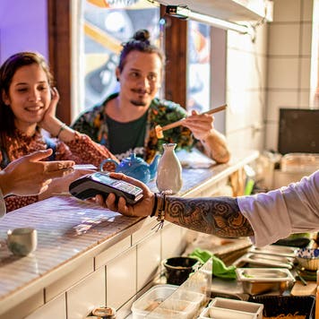 Small group of friends enjoying sushi at the local sushi bar