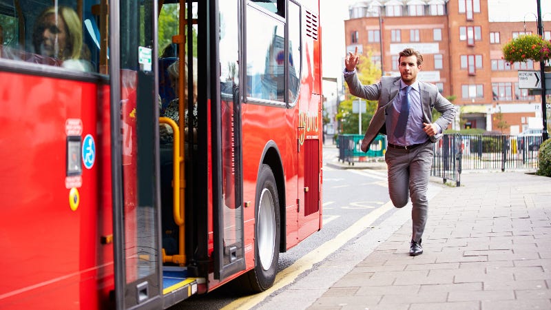 A man runs to catch a bus.