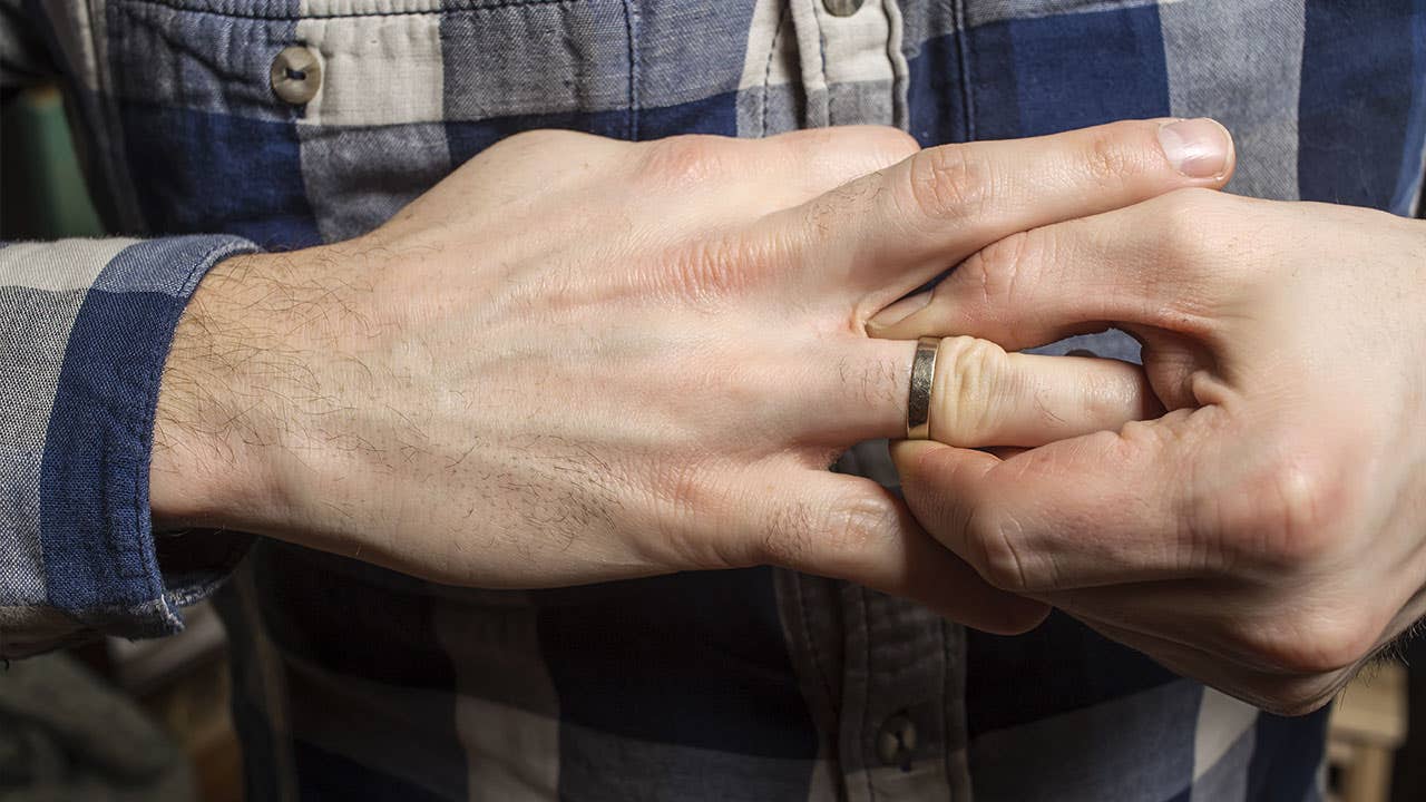 Man removing wedding ring