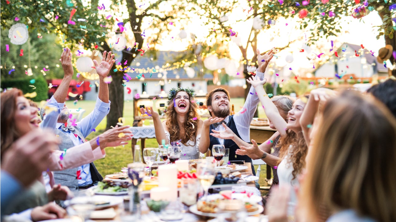 People celebrate at an outdoor wedding reception