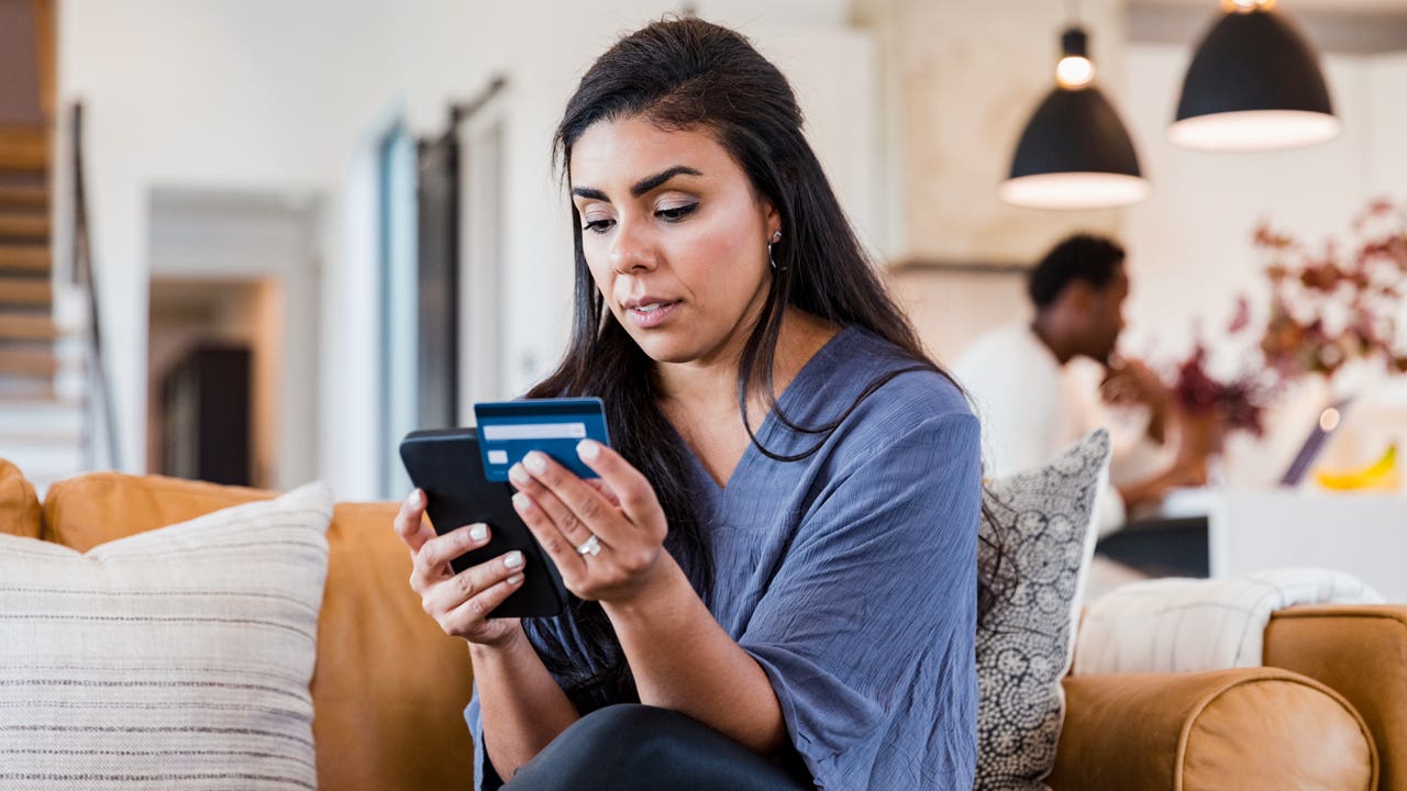 woman using credit card and smartphone