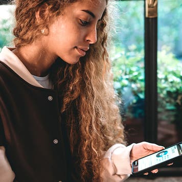 young woman checking her banking account on her phone