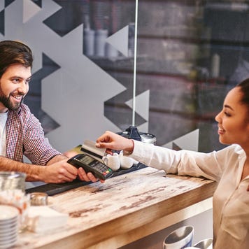 Woman pays for coffee with credit card
