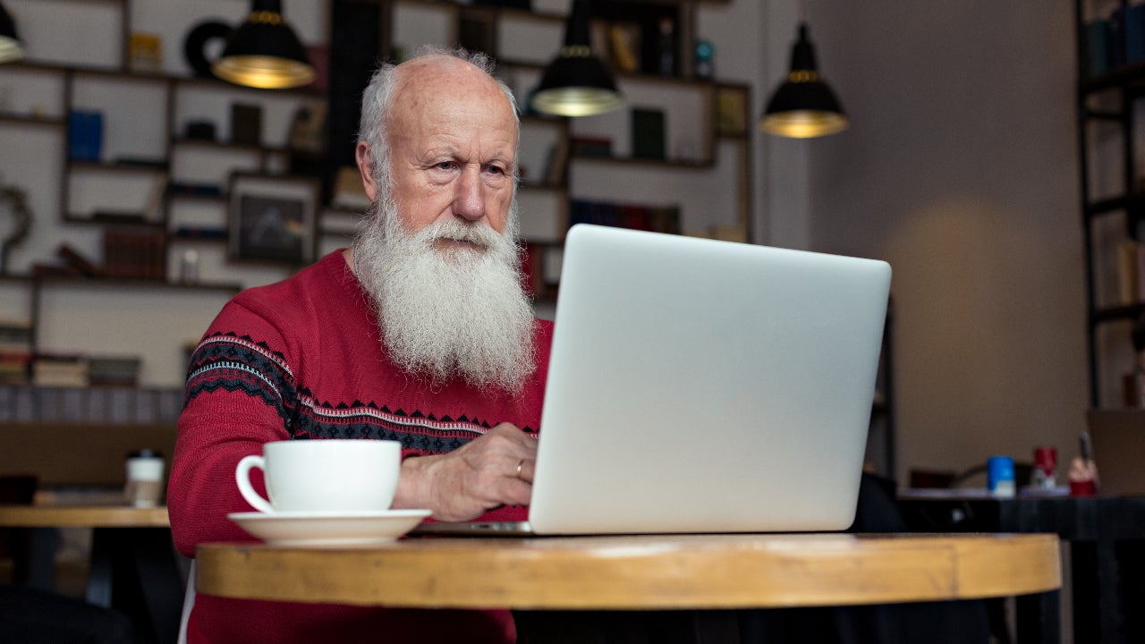 An older man researches online.