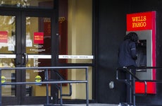 A woman uses a Wells Fargo ATM.