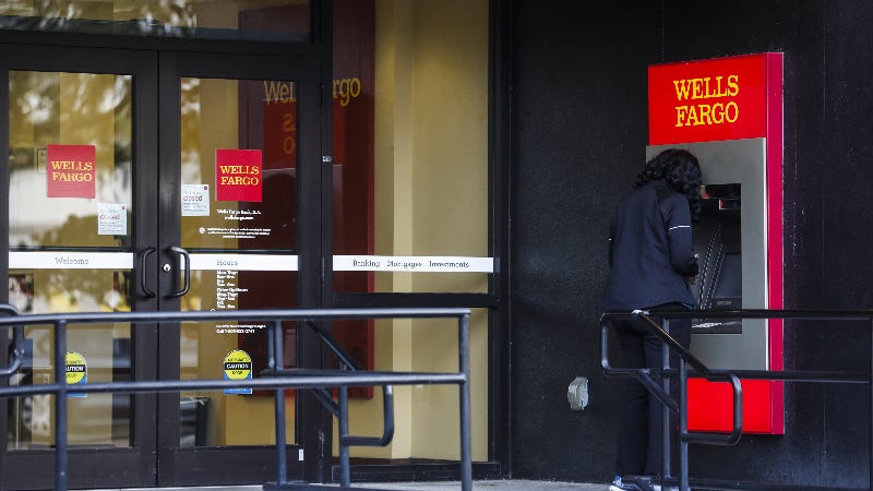 A woman uses a Wells Fargo ATM.