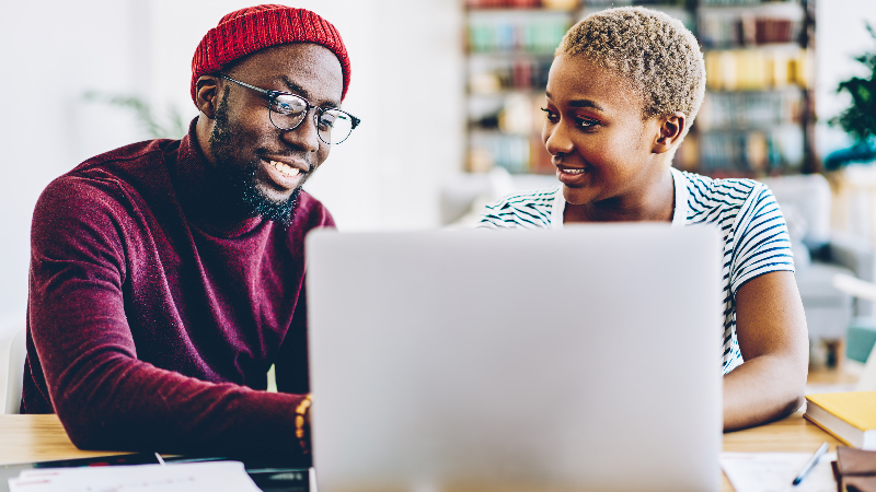 couple at desk browsing on laptop