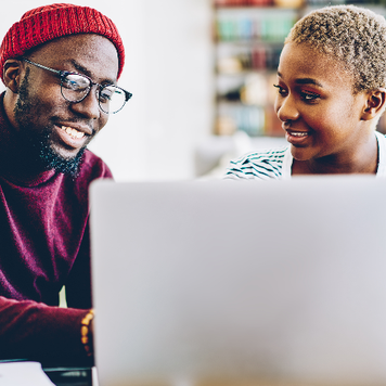 couple at desk browsing on laptop