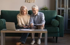 An older couple researches their finances together.
