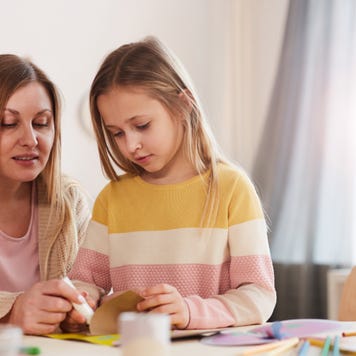 A white mother plays with her daughter