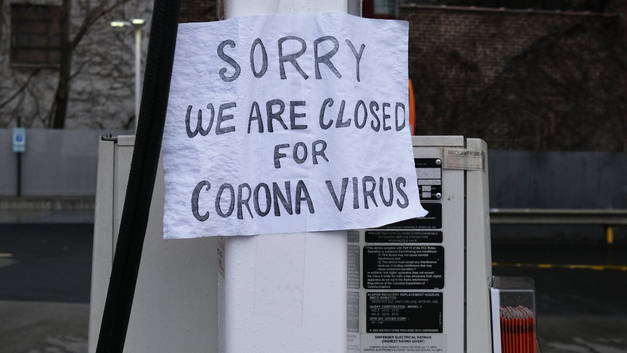 A sign in Queens hangs sign that says "closed for corona virus."