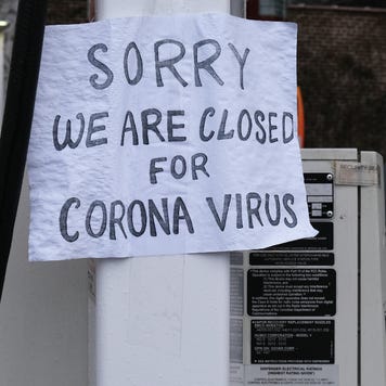 A sign in Queens hangs sign that says "closed for corona virus."