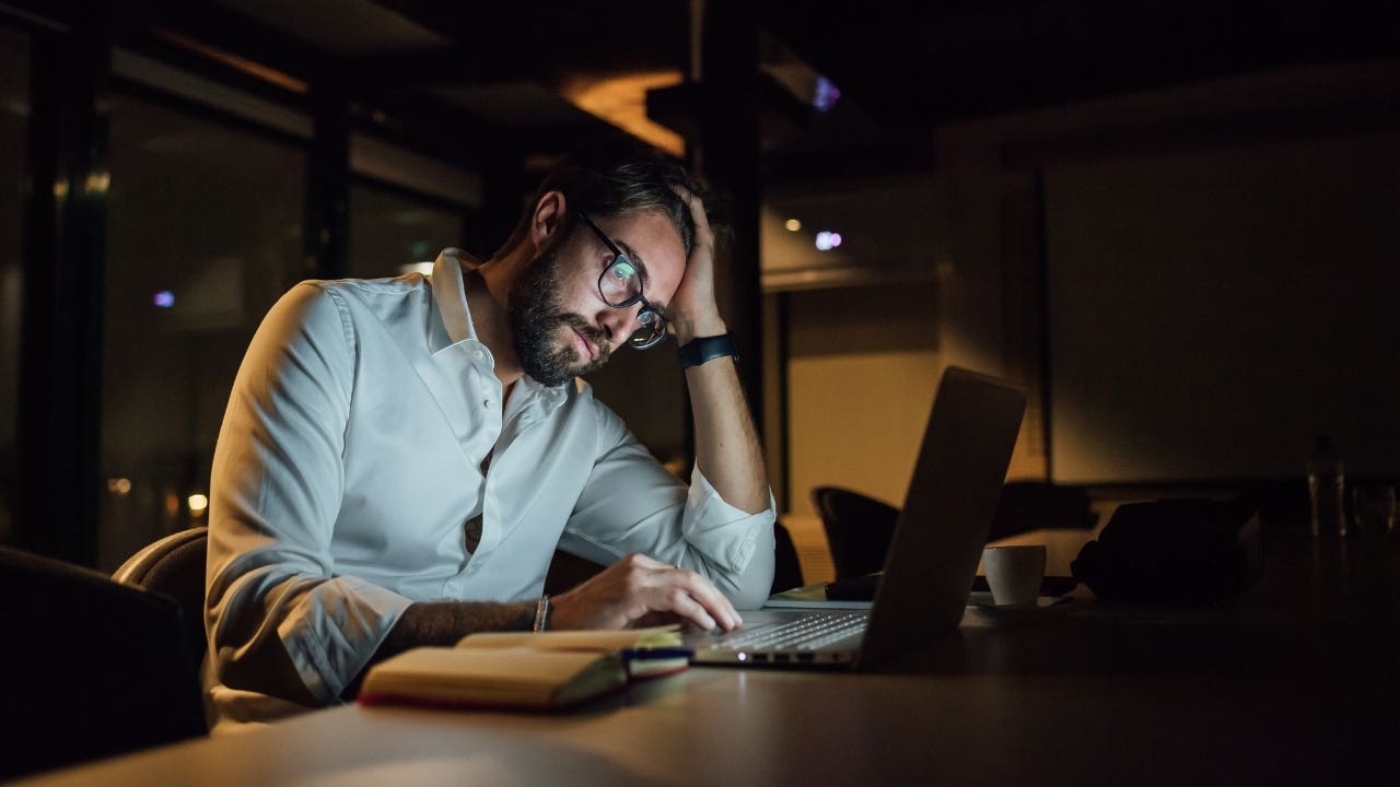 Man on his laptop at night