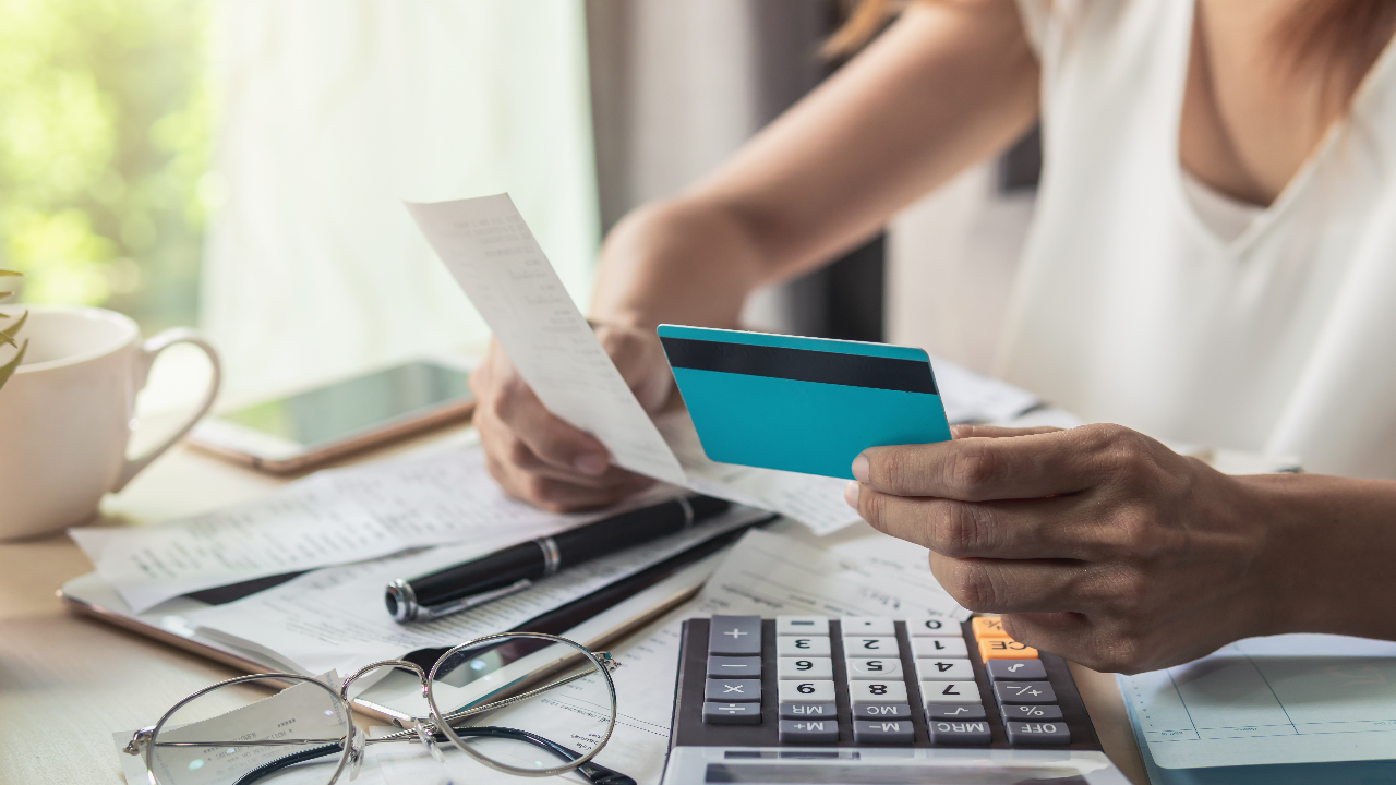 someone holding a receipt and card in hand