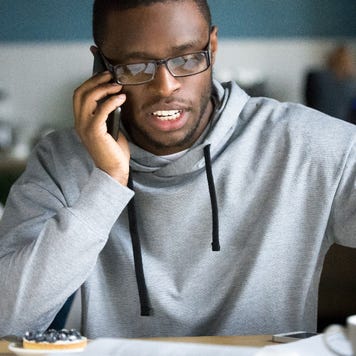 A man at home makes a phone call.