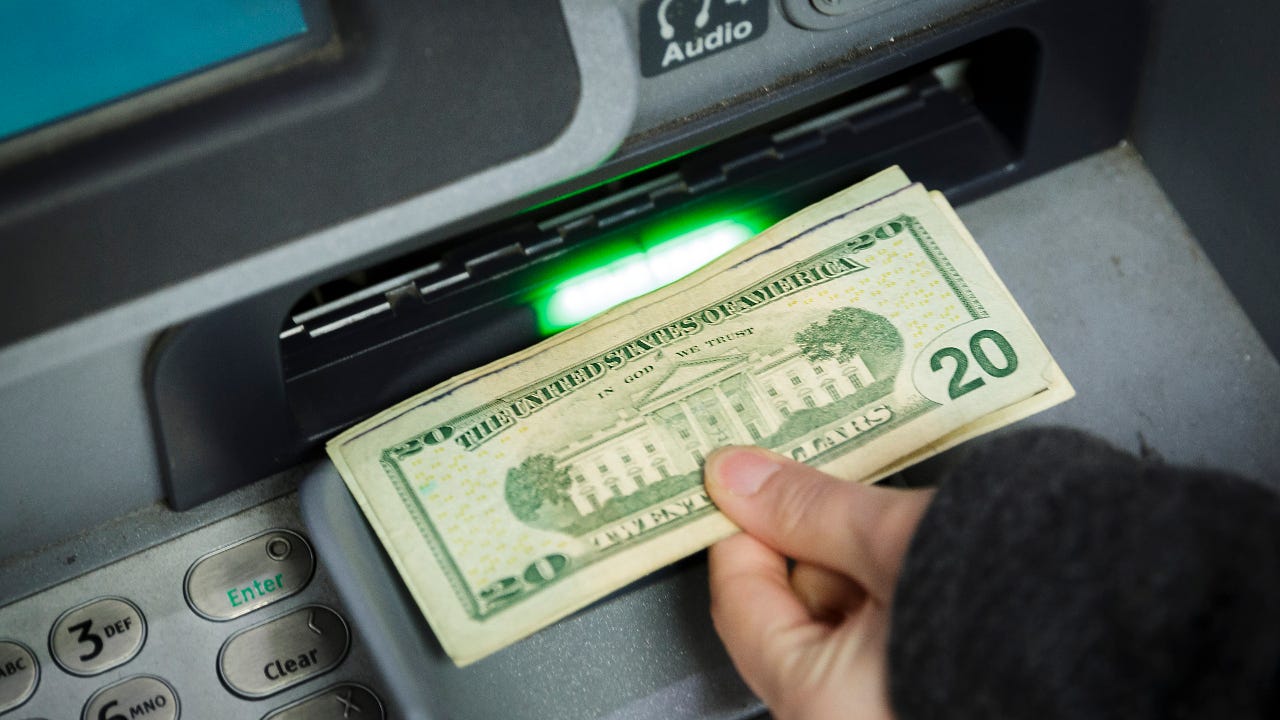 A customer withdraws cash from an ATM.