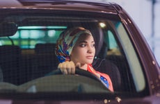 Woman sitting in car at dealership