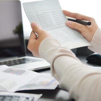 A person is in their home office calculating their taxes