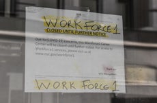 A sign stating that job placement program is closed during coronavirus pandemic.