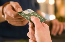 Close-up shot of two people exchanging a credit card