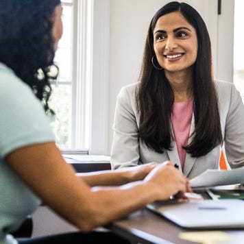 A woman meets with her lender to refinance her mortgage.
