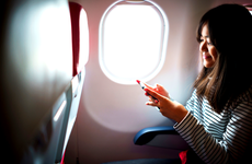 Woman on plane sitting by window
