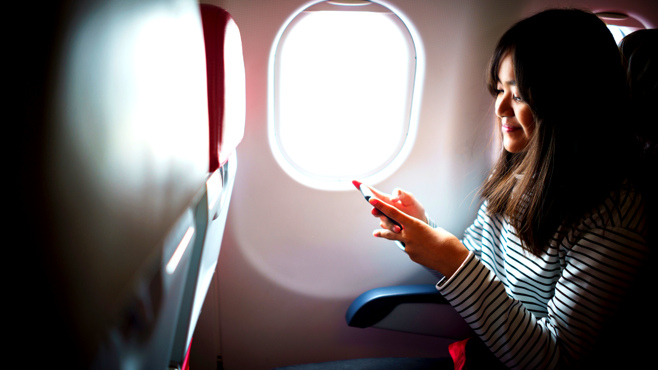 Woman on plane sitting by window