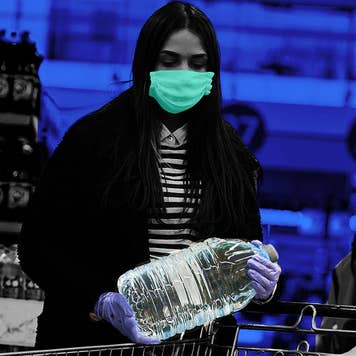 Consumer grabbing water bottle with mask during coronavirus
