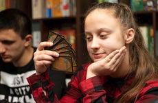 Girl plays Magic: The Gathering game