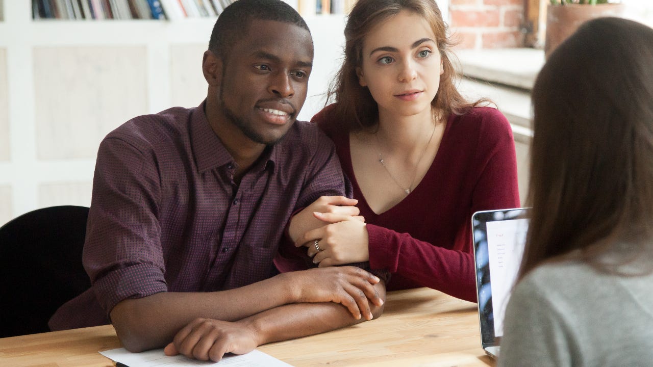 Borrowers meet with a mortgage lender.