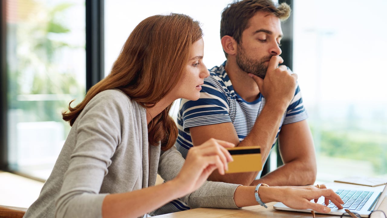 Couple looking at computer with credit card