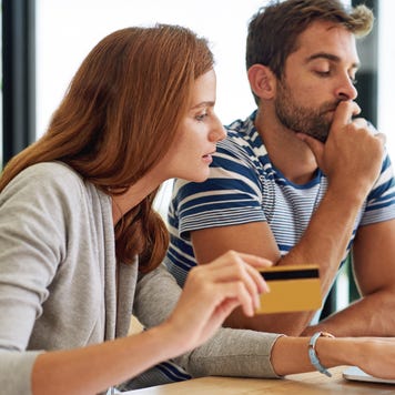 Couple looking at computer with credit card