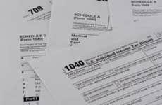 A pile of IRS 1040 tax forms
