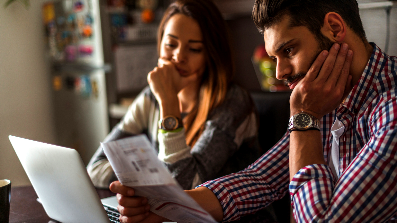 Stressed couple looking at bills