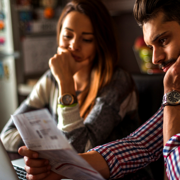 Stressed couple looking at bills