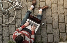 A man researches on his laptop.